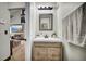 Stylish powder room features a modern vanity with granite countertops and decor at 2235 Meadowmouse St, Orlando, FL 32837