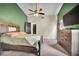 Large bedroom with cathedral ceiling, wood furniture and ceiling fan at 2235 Meadowmouse St, Orlando, FL 32837