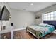 Cozy bedroom features hardwood floors, natural light, and minimalist decor at 2235 Meadowmouse St, Orlando, FL 32837