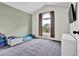 This bedroom features a vaulted ceiling, large window, and neutral paint scheme at 2235 Meadowmouse St, Orlando, FL 32837