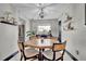 Cozy dining area with a round table, modern lighting, and decorative shelving at 2235 Meadowmouse St, Orlando, FL 32837