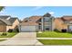 Charming two-story home featuring a two-car garage and well-manicured lawn at 2235 Meadowmouse St, Orlando, FL 32837