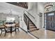 Welcoming foyer with staircase, tile flooring, and a dining area at 2235 Meadowmouse St, Orlando, FL 32837