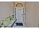 Inviting front entrance featuring a white door with decorative glass and plants at 2235 Meadowmouse St, Orlando, FL 32837
