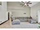 Bright living room with vaulted ceilings, a large sectional sofa, and a ceiling fan at 2235 Meadowmouse St, Orlando, FL 32837