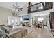Open-concept living room with high ceilings, a ceiling fan, and a large sectional sofa at 2235 Meadowmouse St, Orlando, FL 32837