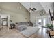 Open living space with vaulted ceilings, a comfortable sectional, and a doorway to the laundry at 2235 Meadowmouse St, Orlando, FL 32837