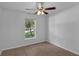 Comfortable bedroom with a ceiling fan and natural light at 253 Churchill Ct, Kissimmee, FL 34758