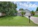 Charming single-story home with a well-manicured lawn, palm trees, and a two-car garage at 253 Churchill Ct, Kissimmee, FL 34758