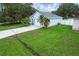 Charming home featuring a well-manicured lawn, mature palm trees, and a paved driveway at 253 Churchill Ct, Kissimmee, FL 34758