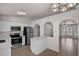 Well-lit kitchen with stainless steel appliances and a convenient breakfast bar at 253 Churchill Ct, Kissimmee, FL 34758