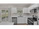 Charming kitchen with stainless steel appliances and a bright window at 253 Churchill Ct, Kissimmee, FL 34758
