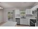Bright kitchen featuring stainless steel appliances and backyard access at 253 Churchill Ct, Kissimmee, FL 34758