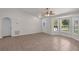 Open living area featuring tile flooring, a ceiling fan, and lots of natural light from the front windows at 253 Churchill Ct, Kissimmee, FL 34758