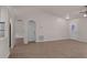 Bright living room with tile flooring, neutral paint, and arched passageways to the kitchen and bedrooms at 253 Churchill Ct, Kissimmee, FL 34758