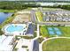 Aerial view of resort-style community pool, clubhouse, tennis courts, and playground at 3099 Ella Way, St Cloud, FL 34771