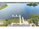 Aerial view of community dock and boat launch area surrounded by lush greenery and a serene lake at 3099 Ella Way, St Cloud, FL 34771