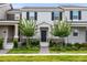Charming townhome featuring well-manicured landscaping, a welcoming front porch, and classic architectural details at 3099 Ella Way, St Cloud, FL 34771