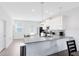 Modern kitchen featuring white cabinets, stainless steel appliances, quartz countertops and an open and airy design at 3099 Ella Way, St Cloud, FL 34771