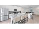 Bright kitchen with stainless steel appliances, a large island with seating, and an open layout perfect for entertaining at 3099 Ella Way, St Cloud, FL 34771