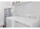 Efficient laundry room with modern washer and dryer, plus storage at 3099 Ella Way, St Cloud, FL 34771