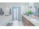 Bathroom featuring double sink vanity, soaker tub, and access to outdoor area at 3160 Whisper Wind Dr, St Cloud, FL 34771