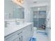 Modern bathroom with double vanity, glass shower, and stylish blue tile accents at 3160 Whisper Wind Dr, St Cloud, FL 34771