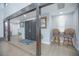 Inviting entryway with wood-look tile, striking dark wood beam, double doors, and natural light at 3160 Whisper Wind Dr, St Cloud, FL 34771