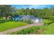 Beautiful white home with lush landscaping and a well-maintained lawn at 3160 Whisper Wind Dr, St Cloud, FL 34771