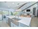 The kitchen features an open-concept layout with modern appliances, a center island, and barstool seating at 3160 Whisper Wind Dr, St Cloud, FL 34771