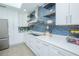 Stylish kitchen with white cabinetry, stainless appliances, and eye-catching backsplash tile at 3160 Whisper Wind Dr, St Cloud, FL 34771