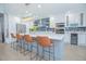 Bright kitchen featuring white cabinets, large island with seating, and stainless steel appliances at 3160 Whisper Wind Dr, St Cloud, FL 34771