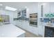 Modern kitchen boasts white cabinets, quartz counters, stainless appliances, and bold backsplash at 3160 Whisper Wind Dr, St Cloud, FL 34771