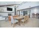 Spacious living and dining area with high ceilings, rustic beams, and abundant natural light at 3160 Whisper Wind Dr, St Cloud, FL 34771