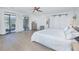 Spacious main bedroom with sliding glass doors, wood-look flooring, and an ensuite bathroom at 3160 Whisper Wind Dr, St Cloud, FL 34771