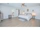 Spacious main bedroom with wood-look tile, closet, and ensuite bathroom at 3160 Whisper Wind Dr, St Cloud, FL 34771