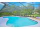 Beautiful in-ground pool with screened enclosure and landscaped surroundings at 3160 Whisper Wind Dr, St Cloud, FL 34771
