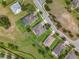 Aerial view of a property showcasing its well-manicured lawn, neighboring homes, and proximity to the street at 31980 Geoff Way, Sorrento, FL 32776