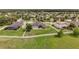 Aerial shot of a property showing its spacious, fenced backyard and surrounding neighborhood, highlighting its desirable location at 31980 Geoff Way, Sorrento, FL 32776