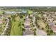 Wide angle aerial view of the community, pond, golf course, and well manicured lawns at 31980 Geoff Way, Sorrento, FL 32776
