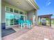 Covered patio area with outdoor seating and grill, perfect for entertaining at 31980 Geoff Way, Sorrento, FL 32776