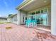 Covered patio with outdoor dining set, offering a peaceful backyard view at 31980 Geoff Way, Sorrento, FL 32776