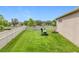 Manicured backyard with lush green lawn and a white fence at 31980 Geoff Way, Sorrento, FL 32776