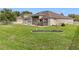 Large backyard showcasing a pergola-covered patio and lush green lawn at 31980 Geoff Way, Sorrento, FL 32776