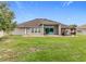Expansive backyard featuring a pergola-covered patio, lush lawn, and white picket fence, perfect for outdoor living at 31980 Geoff Way, Sorrento, FL 32776