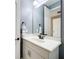 Bathroom featuring a white vanity with a neutral countertop, dark hardware, and a decorative towel at 31980 Geoff Way, Sorrento, FL 32776