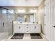Bathroom featuring double sink vanity, large mirror, modern lighting, and walk-in shower at 31980 Geoff Way, Sorrento, FL 32776