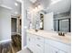Bathroom with dual sinks, a large mirror, and tile flooring that offers elegance and style at 31980 Geoff Way, Sorrento, FL 32776