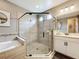 Modern bathroom with double shower head walk-in shower, soaking tub, and vanity at 31980 Geoff Way, Sorrento, FL 32776