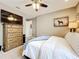 Comfortable bedroom with a chest, TV, ceiling fan, and doorway to another room at 31980 Geoff Way, Sorrento, FL 32776